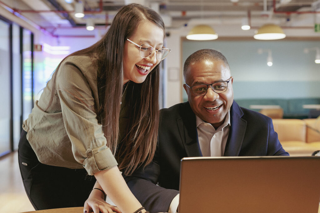 Should a Solo Therapist Outsource Billing? 7 Questions to Ask 2 Michael Williams discussing whether to outsource therapy billing with a team member at a laptop